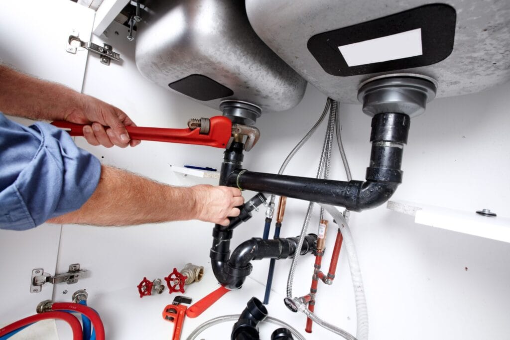 Wildwood Plumbing Pros fixing under sink plumbing and drain pipes