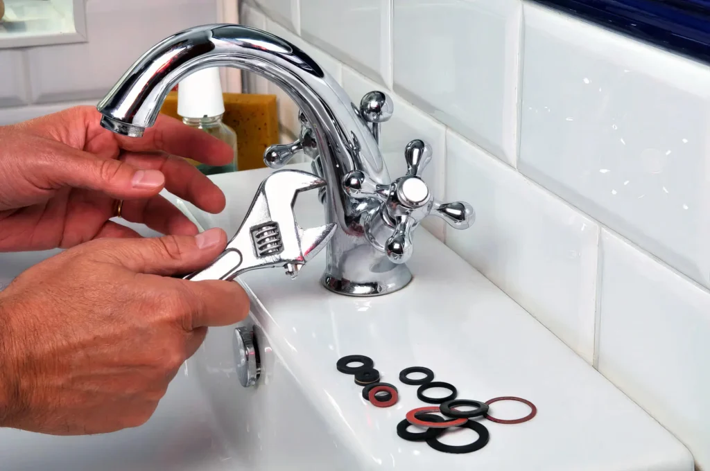Plumber performing maintenance on a bathroom faucet in Wildwood